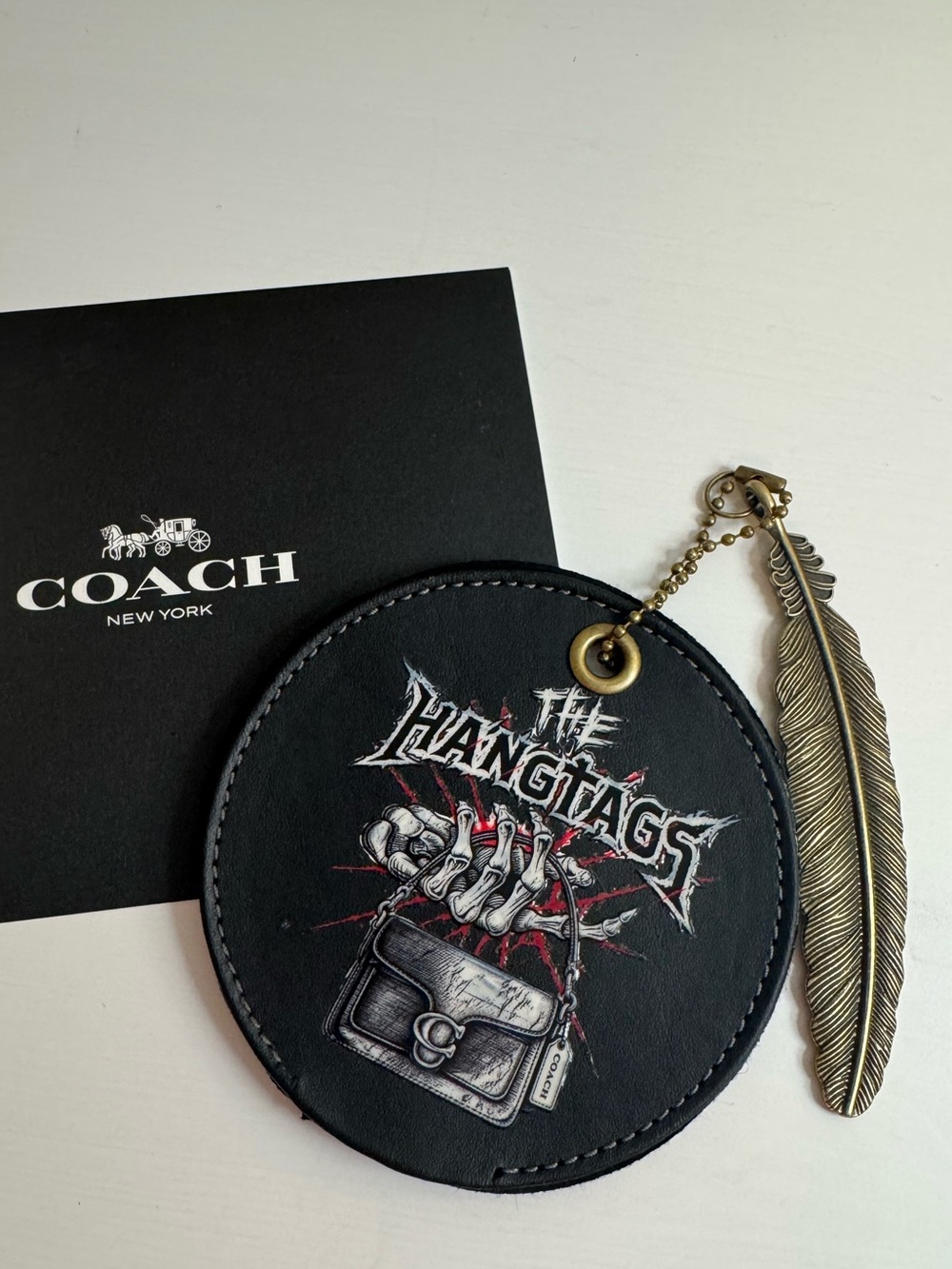 Coach coaster the hangtag charm keychain with feather charm
